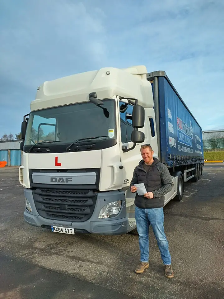 Driver beside a DAF lorry at Pole Position Driver Training Livingston
